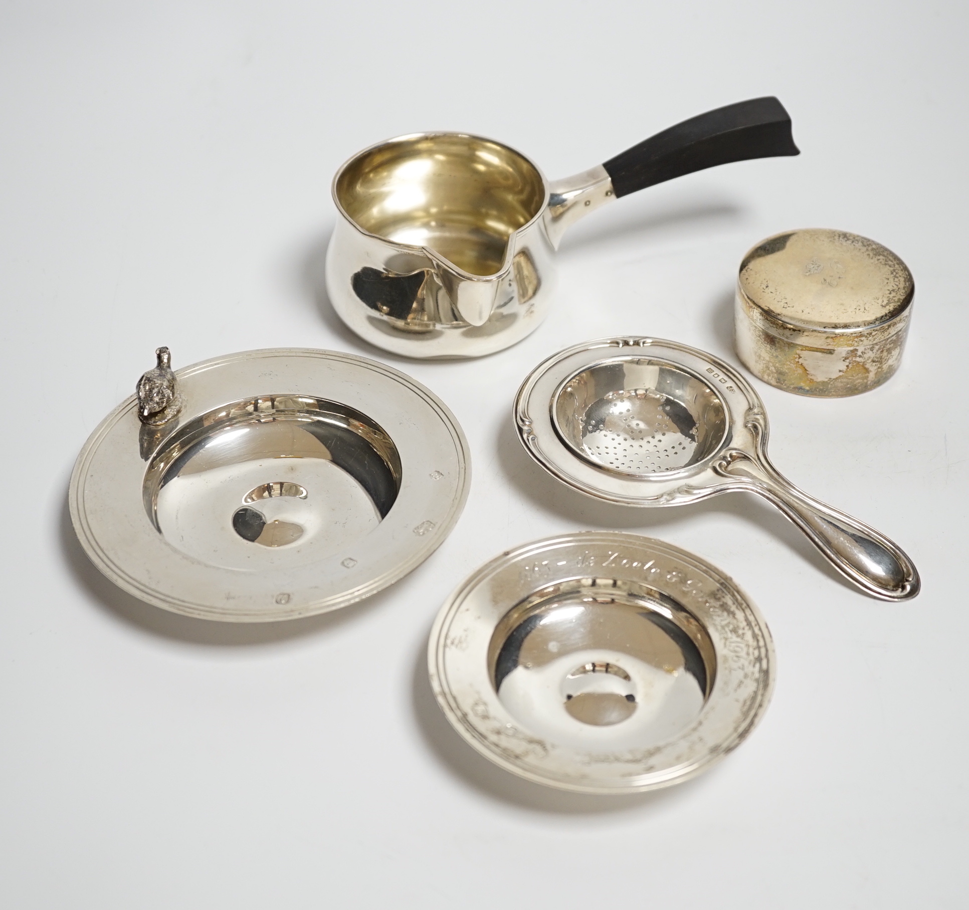 Two small modern silver dishes, a silver tea strainer and two Scandinavian items.